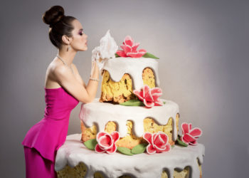 How did the tradition of women jumping out of huge cakes start?